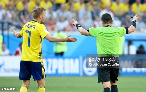 Referee Joel Aguilar of Salvador shows the sign he'll use the video system VAR to allow a penalty for Sweden while Sebastian Larsson of Sweden looks...