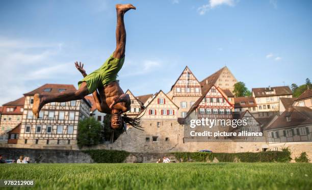 Capoeira coach Formando Shock trains at an open field in Schwaebisch Hall, Germany, 22 April 2018. Photo: Sebastian Gollnow/dpa