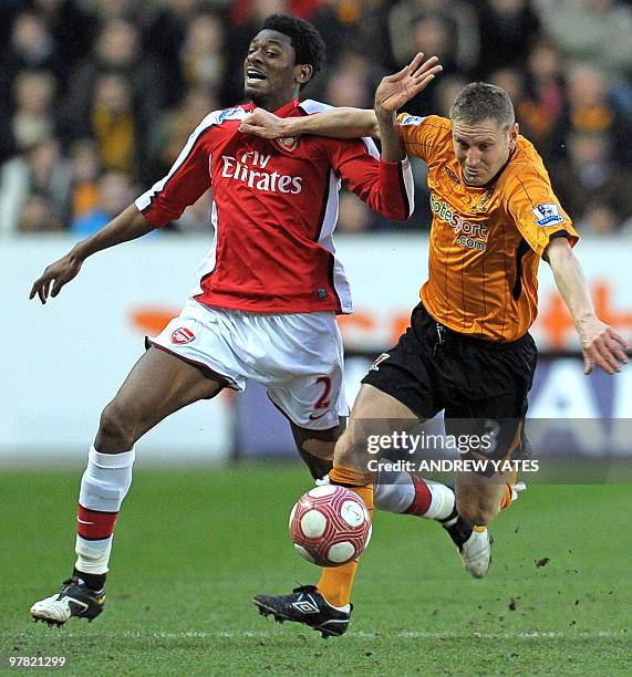 Arsenal's French midfielder Abou Diaby vies with Hull City's English defender Andy Dawson during the English Premier League football match between...