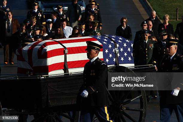 Caisson team carries the remains of four U.S. Soldiers, who died in a helicopter crash in Iraq in 2009, during a group burial service at Arlington...
