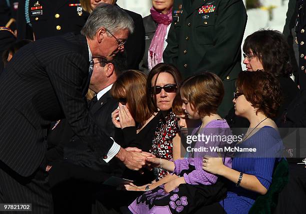 Secretary of the Army John McHugh greets family and friends, including Emalyn Windorki, attending a group burial service for four U.S. Soldiers who...