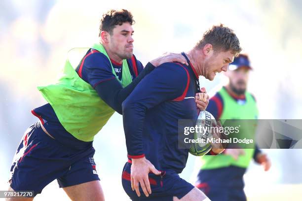 Tom English tackles Matthew Philip during a Melbourne Rebels Super Rugby training session at Gosch's Paddock on June 19, 2018 in Melbourne, Australia.