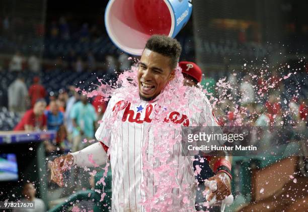 Aaron Altherr of the Philadelphia Phillies gets Powerade dumped on him by Rhys Hoskins after hitting a game winning two-run double in the 10th inning...