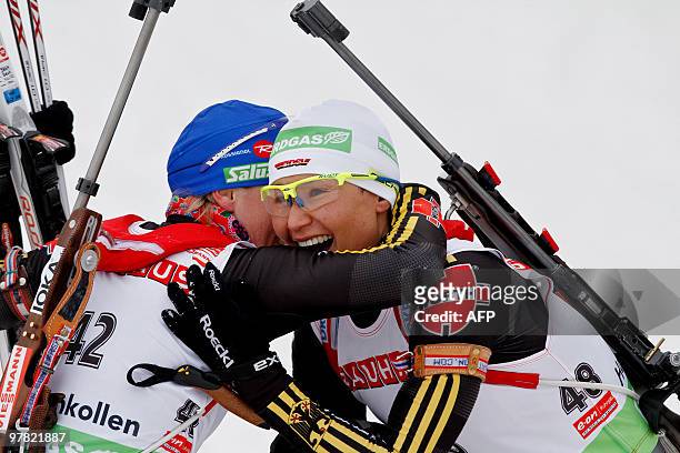 Simone Hauswald of Germany is congratulated by teammate Martina Beck after she won the 7,5 km sprint distance for women in the Holmenkollen WC...