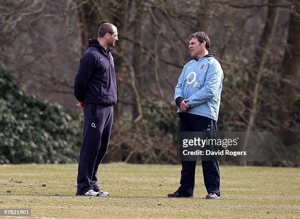 John Wells, the England forwards coach talks to Steve Borthwick during the England training session held at Pennyhill Park on March 17, 2010 in...