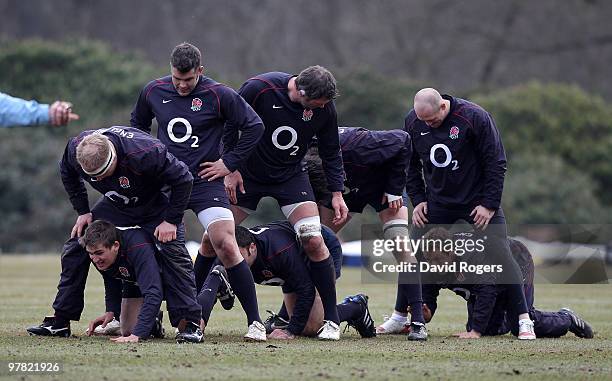 Jonny Wilkinson crawls through the legs of team mates in the warm up during the England training session held at Pennyhill Park on March 17, 2010 in...