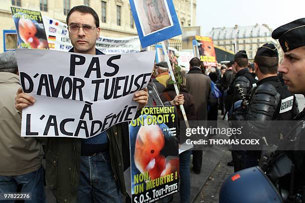 Anti-abortion demonstrators protest on March 18, 2010 in front of the Institute of France in Paris during the welcoming reception of French former...