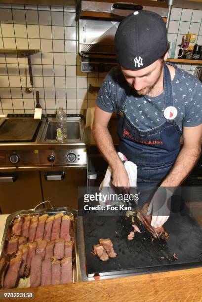 Waiter slices a beef rib during the "Filles A Cotelettes" Party Hosted by Grand Seigneur Magazine at Grocery/Bar Bel Ordinaire on June 18, 2018 in...