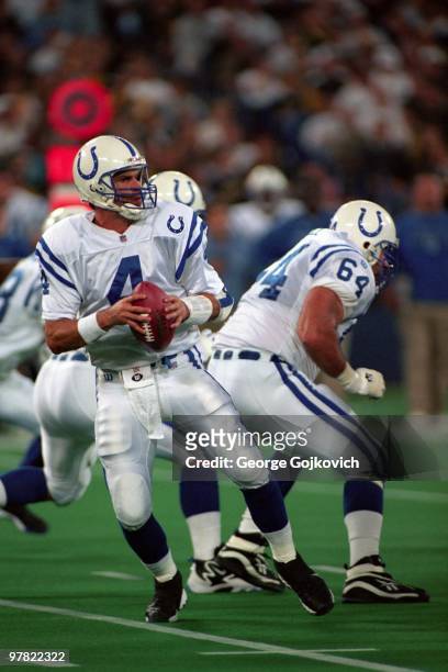 Quarterback Jim Harbaugh of the Indianapolis Colts drops back to pass behind the blocking of offensive lineman Doug Widell during a game against the...