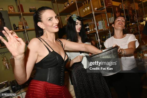 Sylvie Ortega Munos, Elsa Oesinger and a guest attend a tombola during the "Filles A Cotelettes" Party Hosted by Grand Seigneur Magazine at...