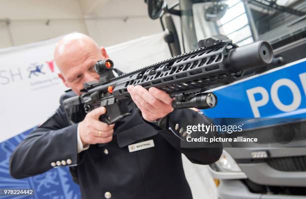 April 2018, Germany, Kiel: Police commissioner Holger Westphal presents a new multicaliber assault rifle of the type MCX of manufacturer Sig Sauer....