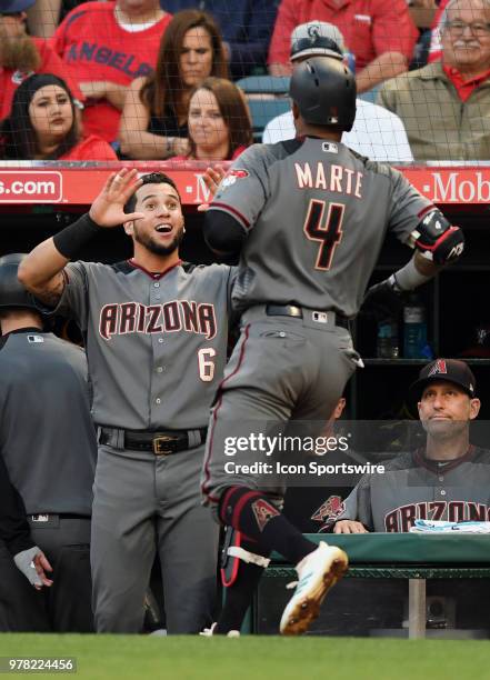 Arizona Diamondbacks left fielder David Peralta greets second baseman Ketel Marte at the dugout after Marte hit a solo home run in the second inning...