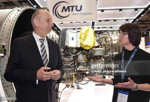 April 2018, Germany, Schoenefeld: Martina Vollmuth, MTU Aero Engines, informs Brandenburg's Premier Dietmar Woidke of the Social Democratic Party ,...
