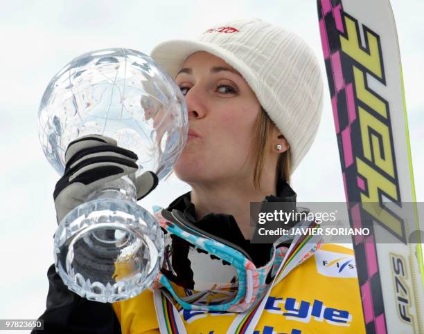 Canada's Jennifer Heil kisses her trophy of World Cup winner after women's Freestyle skiing World Cup Moguls at Sierra Nevada Ski resort, on March...