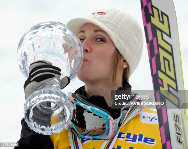 Canada's Jennifer Heil kisses her trophy of World Cup winner after women's Freestyle skiing World Cup Moguls at Sierra Nevada Ski resort, on March...