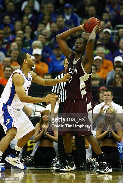 Bryan Davis of the Texas A&M Aggies looks to pass as he is defended by Xavier Henry of the Kansas Jayhawks during the semifinals of the 2010 Phillips...