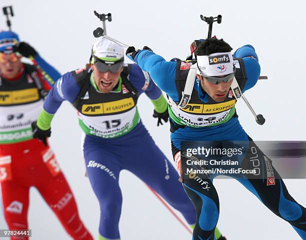 Martin Fourcade of France leads Klemen Bauer of Slovenia on his way to the second season victory during the men's sprint in the E.On Ruhrgas IBU...