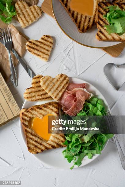 heart egg on toast bread - egg white background stock-fotos und bilder