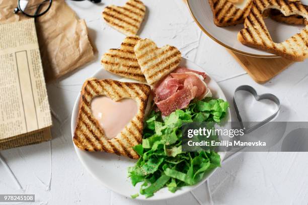 heart egg on toast bread - egg white background stock-fotos und bilder