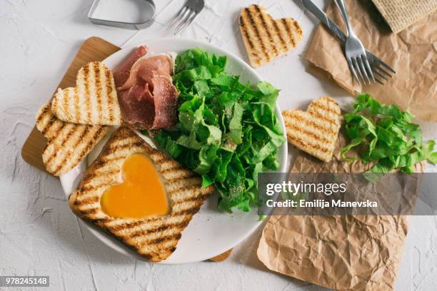 heart egg on toast bread - egg white background stock-fotos und bilder