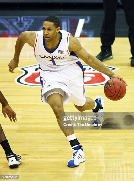 Xavier Henry of the Kansas Jayhawks dribbles around the defense of the Texas A&M Aggies during the semifinals of the 2010 Phillips 66 Big 12 Men's...