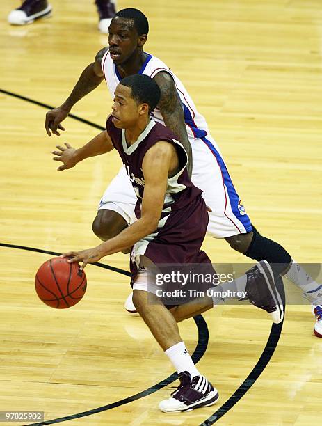Holmes of the Texas A&M Aggies tries to dribble around Tyshawn Taylor of the Kansas Jayhawks during the semifinals of the 2010 Phillips 66 Big 12...