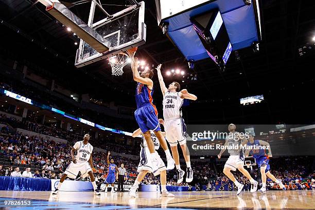 Dan Werner of the Florida Gators drives for a shot attempt against Noah Hartsock of the BYU Cougars during the first round of the 2010 NCAA men�s...