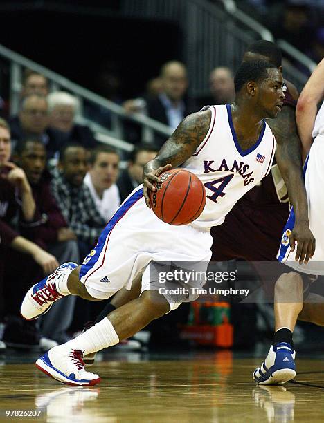 Sherron Collins of the Kansas Jayhawks tries to dribble around the defense of the Texas A&M Aggies during the 2010 Phillips 66 Big 12 Men's...