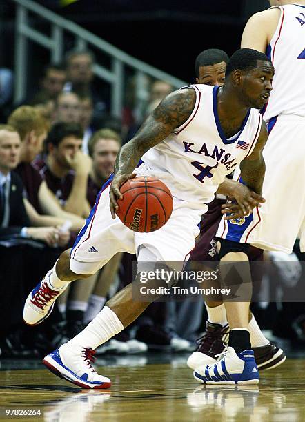 Sherron Collins of the Kansas Jayhawks tries to dribble around the defense of the Texas A&M Aggies during the 2010 Phillips 66 Big 12 Men's...