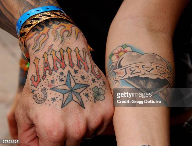 Jesse James & his wife Janine show their names that are tattoo'd on them