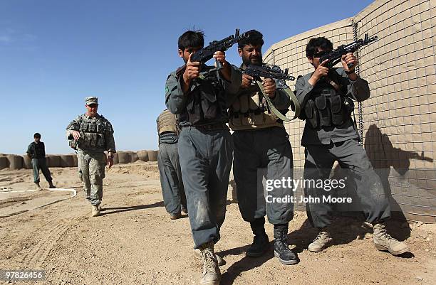 Army advisor trains Afghan national policemen in close quarters battle techniques on March 18, 2010 at Forward Operating Base Ramrod in Kandahar...