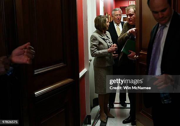 Speaker of the House Nancy Pelosi talks with House Majority Leader Steny Hoyer as they arrive for an event highlighting health care reform at the...