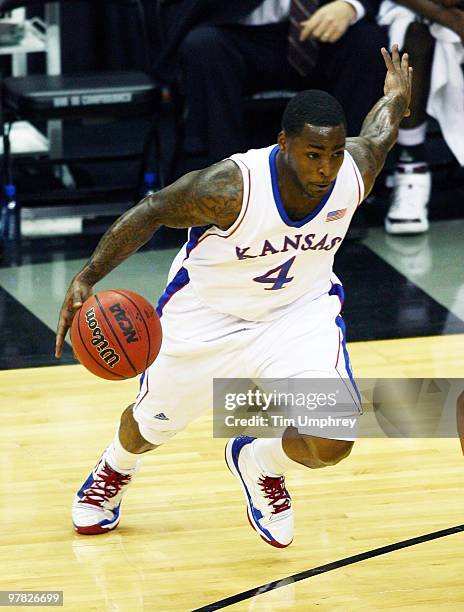 Sherron Collins of the Kansas Jayhawks tries to dribble around the defense of the Texas A&M Aggies during the 2010 Phillips 66 Big 12 Men's...