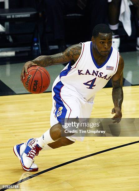 Sherron Collins of the Kansas Jayhawks tries to dribble around the defense of the Texas A&M Aggies during the 2010 Phillips 66 Big 12 Men's...