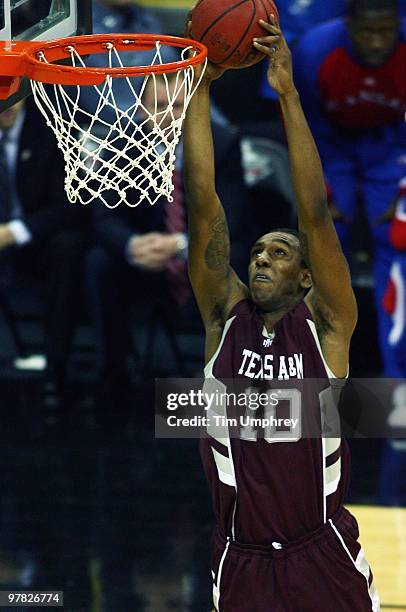 David Loubeau of the Texas A&M Aggies dunks the ball against the Kansas Jayhawks during the semifinals of the 2010 Phillips 66 Big 12 Men's...