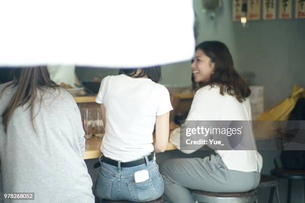 various ethnic friends enjoying a dinner at japanese pub - noren stock pictures, royalty-free photos & images