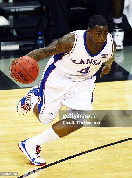 Sherron Collins of the Kansas Jayhawks tries to dribble around the defense of the Texas A&M Aggies during the 2010 Phillips 66 Big 12 Men's...