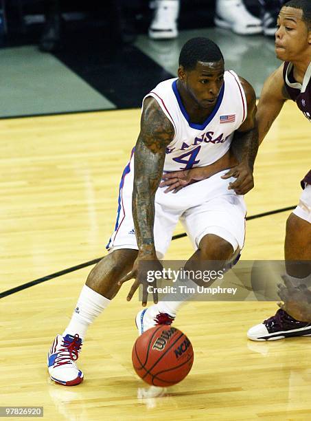 Sherron Collins of the Kansas Jayhawks tries to dribble around the defense of the Texas A&M Aggies during the 2010 Phillips 66 Big 12 Men's...