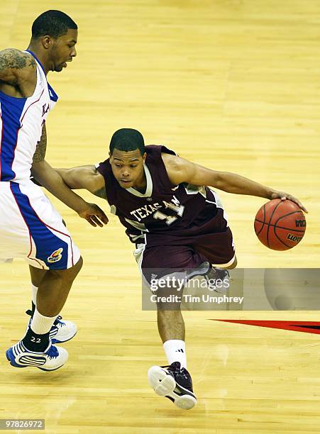 Holmes of the Texas A&M Aggies tries to dribble around the defense of the Kansas Jayhawks during the semifinals of the 2010 Phillips 66 Big 12 Men's...