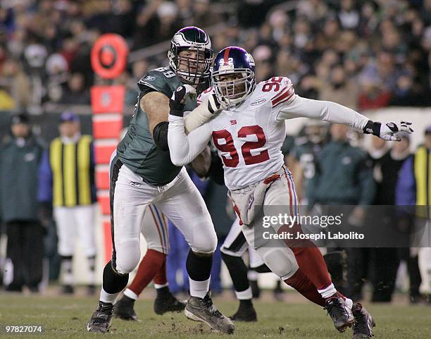 Eagles lineman Jon Runyan and Giants Michael Strahan battle it out. The New York Giants defeated the Philadelphia Eagles 26 to 23 in overtime at...