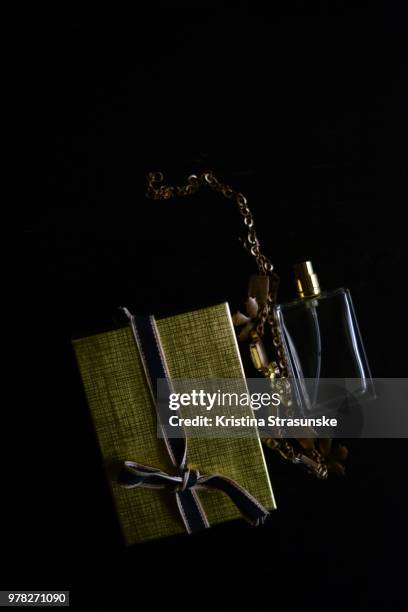 a box with ribbon, a necklace and perfume bottle - kristina strasunske ストックフォトと画像