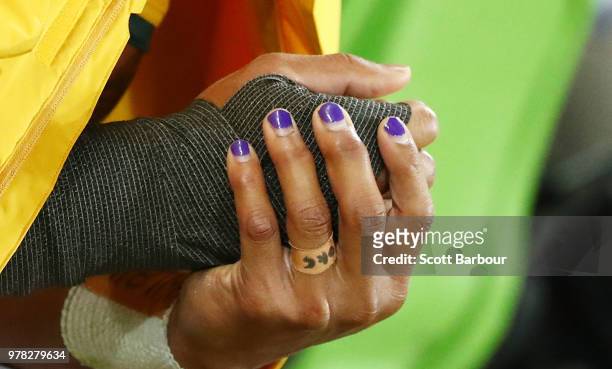 Detail of the painted nails of Will Genia of the Wallabies as he sits on the bench injured during the International test match between the Australian...