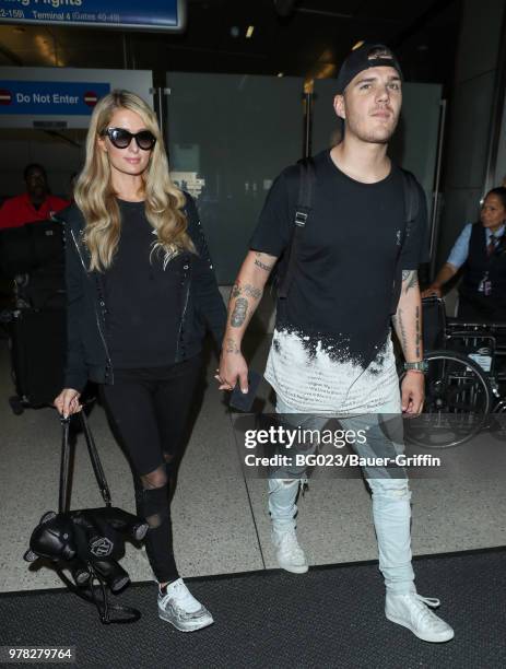 Paris Hilton and Chris Zylka are seen at LAX on June 18, 2018 in Los Angeles, California.