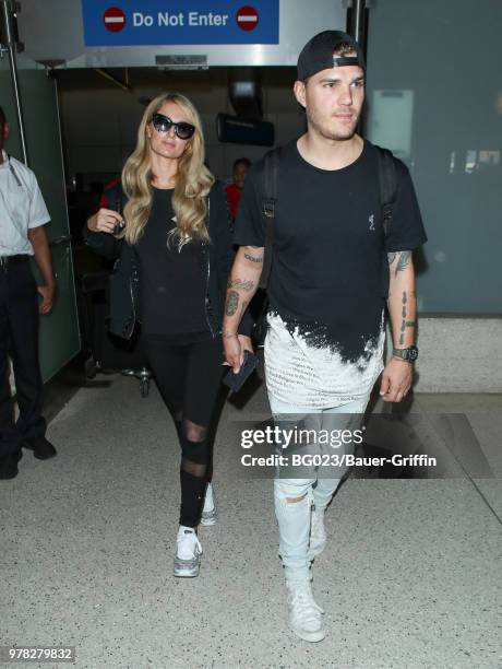 Paris Hilton and Chris Zylka are seen at LAX on June 18, 2018 in Los Angeles, California.