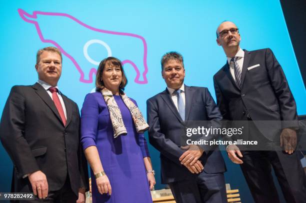 April 2018, Germany, Essen: Hans Buenting , Hildegard Mueller, Uwe Tigges and Martin Herrmann, board members at energy company Innogy, smile at their...