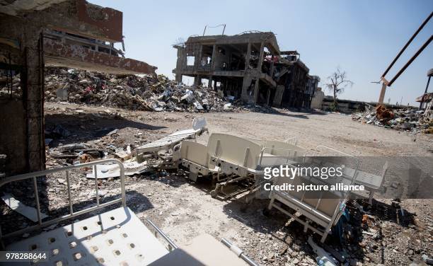 April 2018, Iraq, Mosul: Beds lie around outside a hospital destroyed by the Islamic State. German Development Minister Gerd Mueller of the...