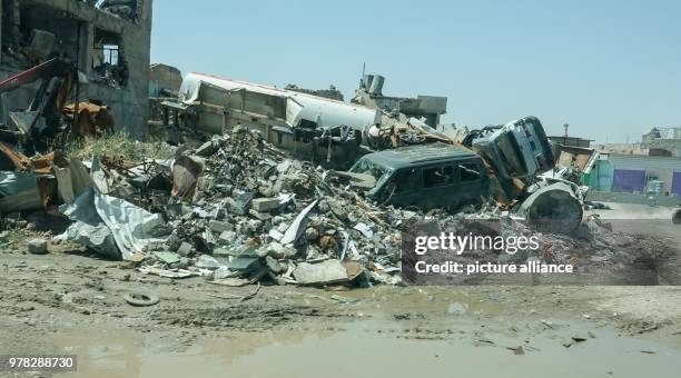 April 2018, Iraq, Mosul: Houses and cars are that were destroyed by the Islamic State litter the city with debris. German Development Minister Gerd...