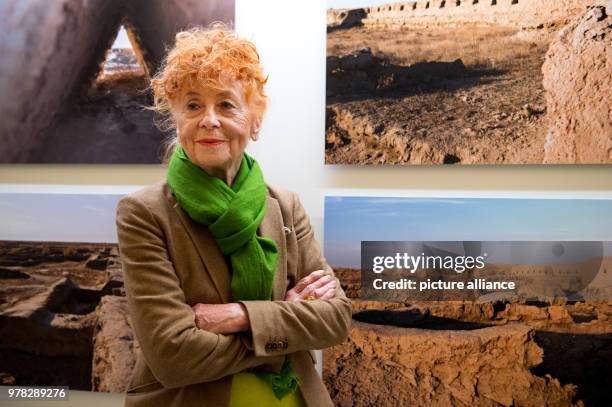 April 2018, Germany, Berlin: Photographer Herlinde Koelbl stands infront of one of her photographs at the exhibition 'Margiana. A Bronze Age Kingdom...