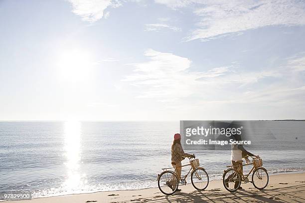 women by the sea with bicycles - cape cod stockfoto's en -beelden
