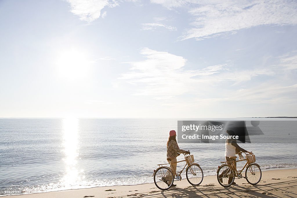 Women by the sea with bicycles